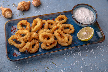 Deep-fried squid or onion rings in batter. Natural delicious food. Greek cuisine menu. Still life...