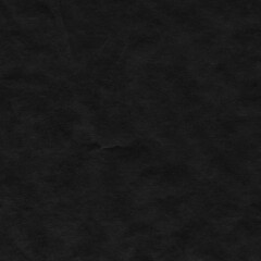 Black vintage and old looking crumpled paper background. Retro cardboard texture. Grunge paper for drawing. Ancient book page. Present wrapping.