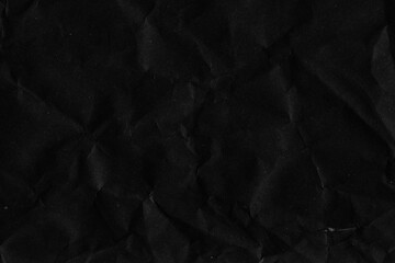 Fototapeta premium Black vintage and old looking crumpled paper background. Retro cardboard texture. Grunge paper for drawing. Ancient book page. Present wrapping.