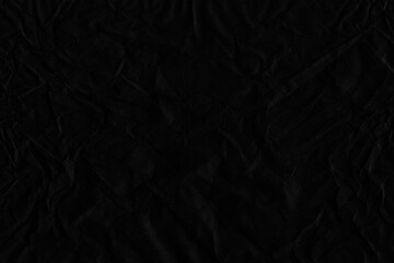 Black vintage and old looking crumpled paper background. Retro cardboard texture. Grunge paper for drawing. Ancient book page. Present wrapping.