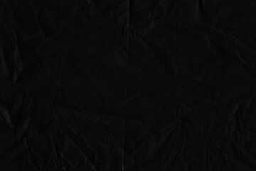 Black vintage and old looking crumpled paper background. Retro cardboard texture. Grunge paper for drawing. Ancient book page. Present wrapping.