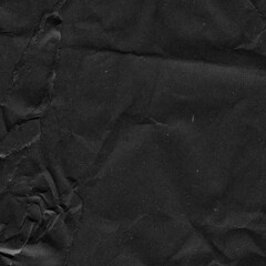 Black vintage and old looking crumpled paper background. Retro cardboard texture. Grunge paper for drawing. Ancient book page. Present wrapping.