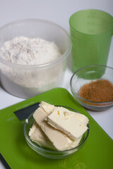 Butter on a kitchen scale. Sugar and flour in containers. Levington cake, stages of preparation.