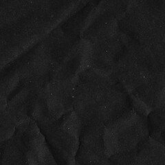 Black vintage and old looking crumpled paper background. Retro cardboard texture. Grunge paper for drawing. Ancient book page. Present wrapping.