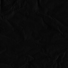 Black vintage and old looking crumpled paper background. Retro cardboard texture. Grunge paper for drawing. Ancient book page. Present wrapping.