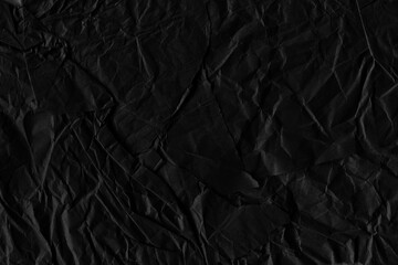 Fototapeta premium Black vintage and old looking crumpled paper background. Retro cardboard texture. Grunge paper for drawing. Ancient book page. Present wrapping.
