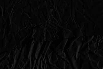 Black vintage and old looking crumpled paper background. Retro cardboard texture. Grunge paper for drawing. Ancient book page. Present wrapping.