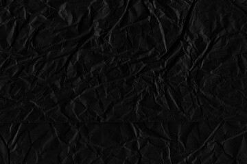 Black vintage and old looking crumpled paper background. Retro cardboard texture. Grunge paper for drawing. Ancient book page. Present wrapping.