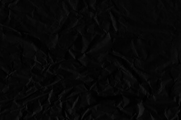 Black vintage and old looking crumpled paper background. Retro cardboard texture. Grunge paper for drawing. Ancient book page. Present wrapping.