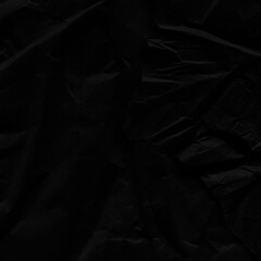 Black vintage and old looking crumpled paper background. Retro cardboard texture. Grunge paper for drawing. Ancient book page. Present wrapping.