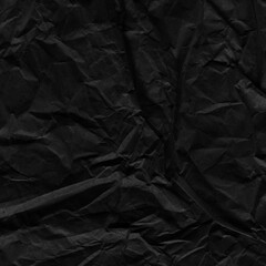 Black vintage and old looking crumpled paper background. Retro cardboard texture. Grunge paper for drawing. Ancient book page. Present wrapping.