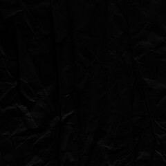 Black vintage and old looking crumpled paper background. Retro cardboard texture. Grunge paper for drawing. Ancient book page. Present wrapping.