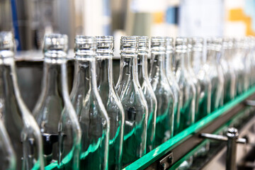 Factory for the production of alcoholic beverages. Bottles of vodka on the conveyor.