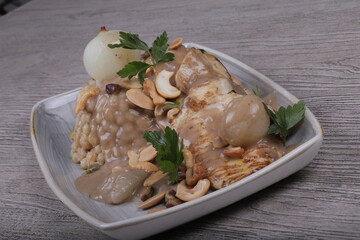 Fish fillet With the grains Dough sauce And chickpeas Decorated With green parsley And cooked onions