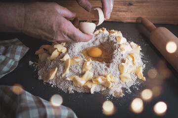 Dough preparation in christmas bakery
Dough preparation with flour, butter and egg for homemade christmas cookies. Concept for baking at home with fresh ingredients and golden bokeh.