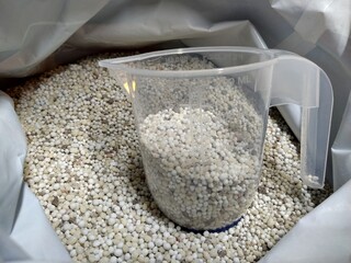 lawn food granules in bag dispensing mug