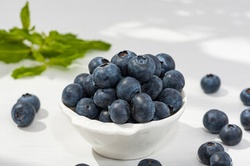 Freshly picked blueberries Blueberry closeup background on a white dish.