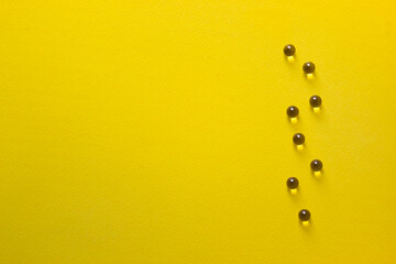 on a yellow bright background vitamina tablets capsules
