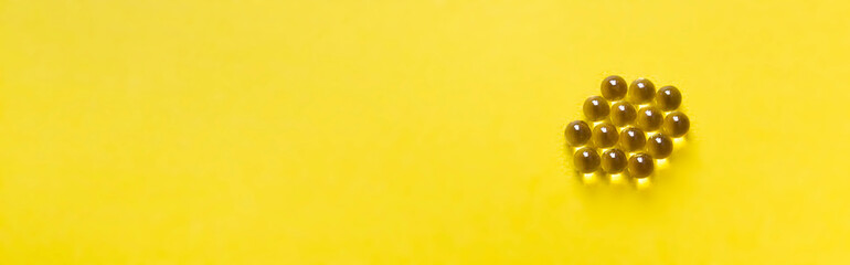 on a yellow bright background vitamina tablets capsules