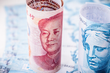 money from china and brazil, banknotes of one hundred reais and banknotes of 100 yuan, or Renminbi....