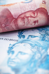 100 reais banknote and one hundred yuan banknote, Chinese leader, detail of a renminbi banknote and a Brazilian banknote. Concept of negotiation between china and brazil