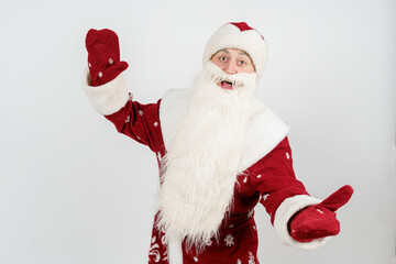 Santa Claus gestures with his hands, spreading them apart from admiration. Isolated background.