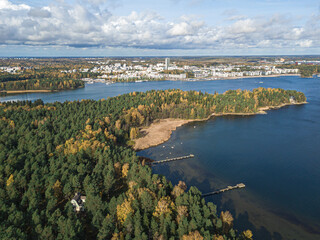 The coastline of the Gulf of Finland and in the horizon you can see Helsinki, a sunny autumn day. Scandinavian nature and landscape. Aerial view from drone