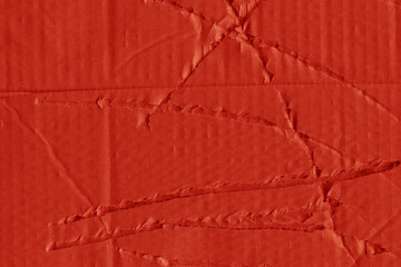 A red vintage rough sheet of carton. Recycled environmentally friendly cardboard paper texture. Simple and bright minimalist papercraft background.