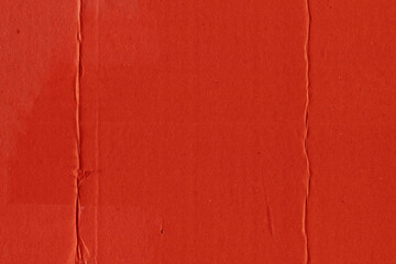 A red vintage rough sheet of carton. Recycled environmentally friendly cardboard paper texture. Simple and bright minimalist papercraft background.
