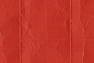 A red vintage rough sheet of carton. Recycled environmentally friendly cardboard paper texture. Simple and bright minimalist papercraft background.
