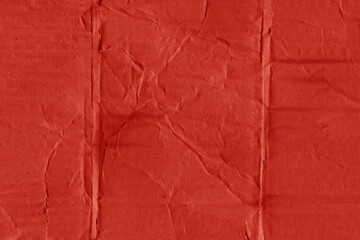 A red vintage rough sheet of carton. Recycled environmentally friendly cardboard paper texture. Simple and bright minimalist papercraft background.
