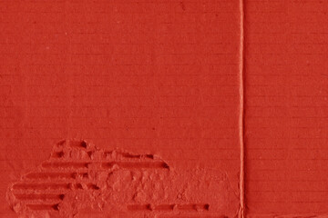 Fototapeta premium A red vintage rough sheet of carton. Recycled environmentally friendly cardboard paper texture. Simple and bright minimalist papercraft background. 