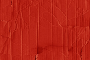 A red vintage rough sheet of carton. Recycled environmentally friendly cardboard paper texture. Simple and bright minimalist papercraft background.
