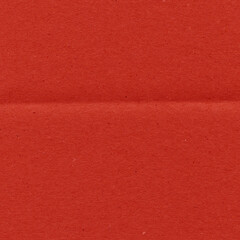A red vintage rough sheet of carton. Recycled environmentally friendly cardboard paper texture. Simple and bright minimalist papercraft background.
