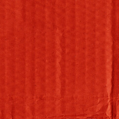 A red vintage rough sheet of carton. Recycled environmentally friendly cardboard paper texture. Simple and bright minimalist papercraft background.
