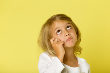 The little girl looks up.The concept of children's emotions.