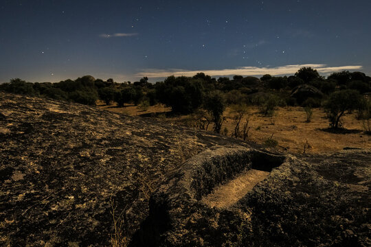 Night landscape with ancient grave in the Barruecos Natural Area. Spain.