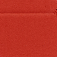 A red vintage rough sheet of carton. Recycled environmentally friendly cardboard paper texture. Simple and bright minimalist papercraft background.

