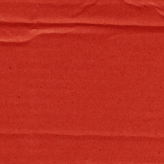 Fototapeta premium A red vintage rough sheet of carton. Recycled environmentally friendly cardboard paper texture. Simple and bright minimalist papercraft background. 