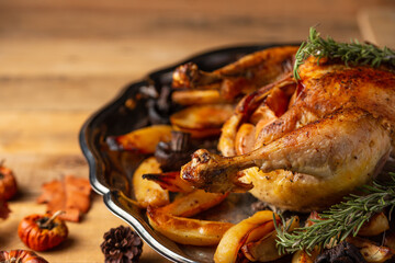 Traditional festive dinner with delicious roasted turkey and baked potatoes served on wooden table. Food for holiday. Thanksgiving day. Concept of festive meal.