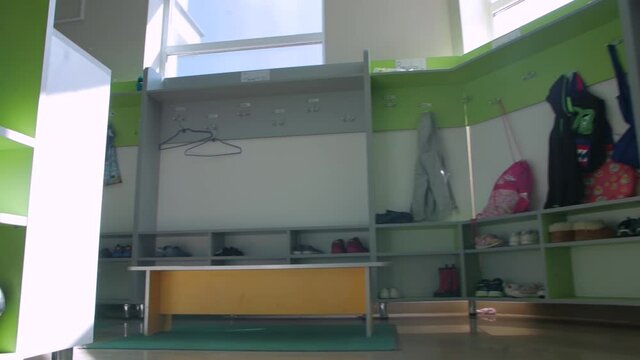 Children school lockers clothes backward push out camera movement