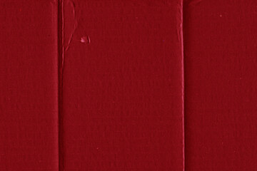 A red vintage rough sheet of carton. Recycled environmentally friendly cardboard paper texture. Simple and bright minimalist papercraft background.