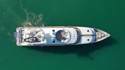 Aerial drone top down photo of luxury yacht cruising to Athens Marina and port in Piraeus, Attica, Greece
