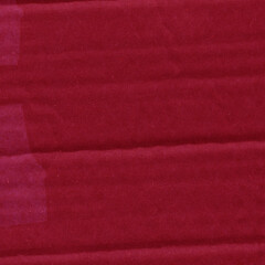 Fototapeta premium A red vintage rough sheet of carton. Recycled environmentally friendly cardboard paper texture. Simple and bright minimalist papercraft background.