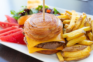 Hamburger with rolled bread served with fries