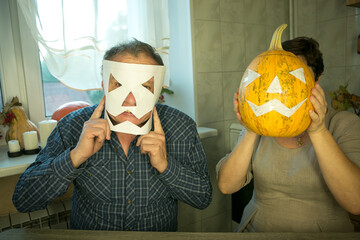 The pumpkin is ready for slicing. The man and the woman are happy with their work and laugh and...