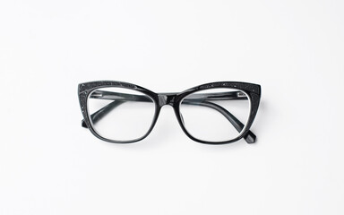 Black eye glasses spectacles with shiny black frame For reading daily life To a person with visual impairment. White background as background health concept with copy space.