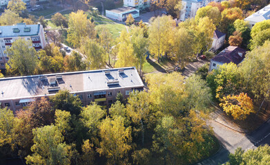 Top view of a beautiful autumn park in the city with houses