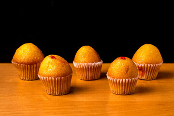 Dessert. Appetizing muffins on a wooden background. Homemade pastries.