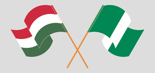 Crossed and waving flags of Nigeria and Hungary